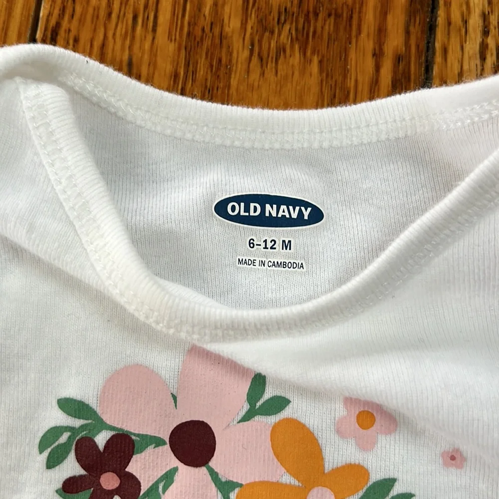 Old Navy white infant girls onsie.Long sleeve w/floral graphic & Love on front